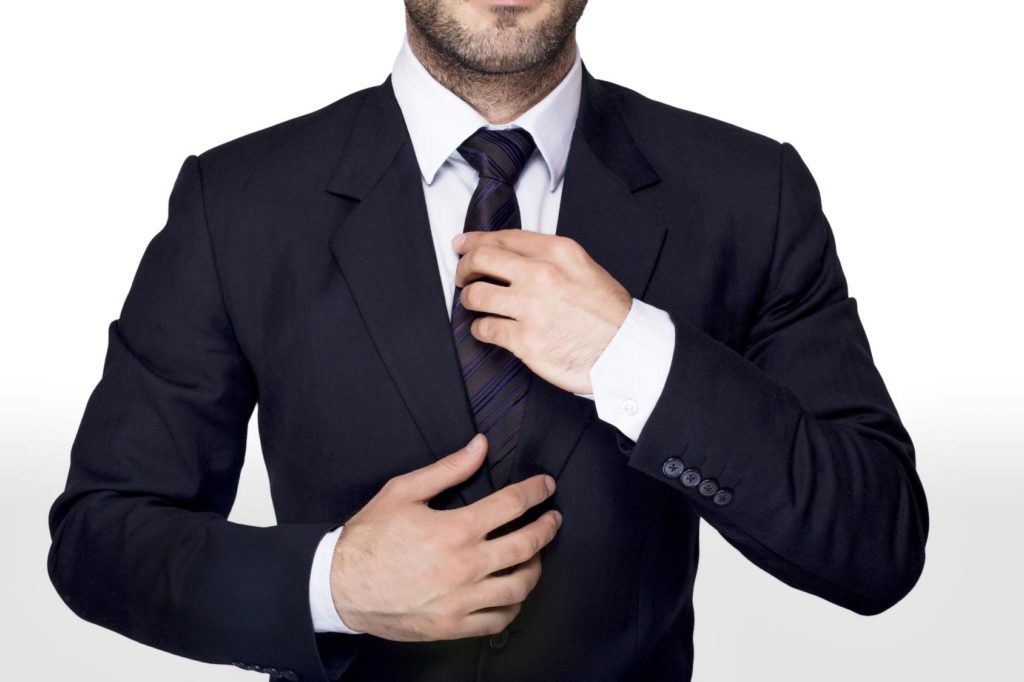 Businessman adjusting a tie